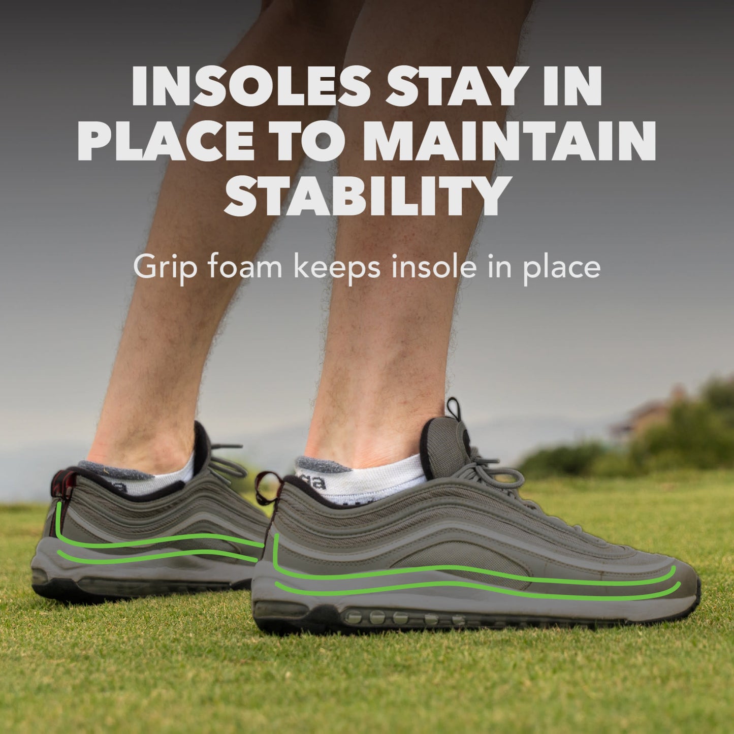 Insoles stay in place to maintain stability on grass with a person wearing sneakers.