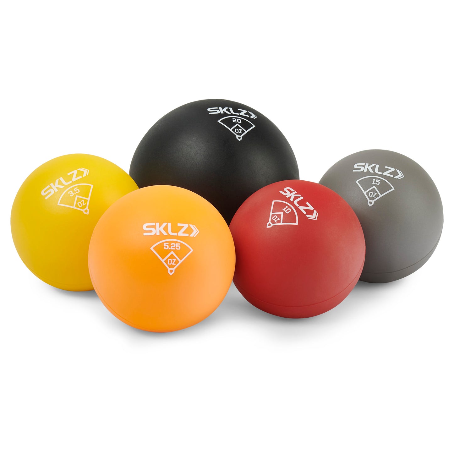Colorful medicine balls are arranged on a white surface in a studio setting.