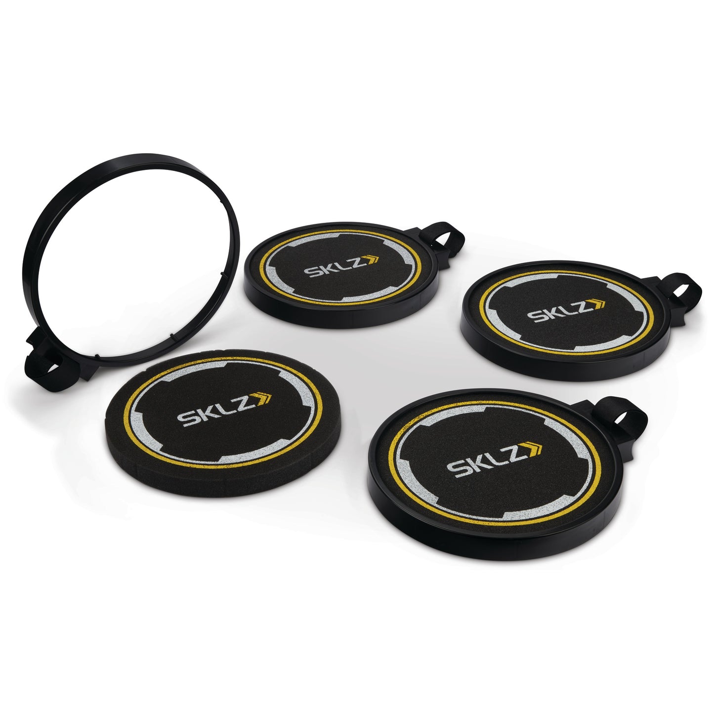 The set of four indexed ski pole guards is arranged on a white surface with a spare part in the background