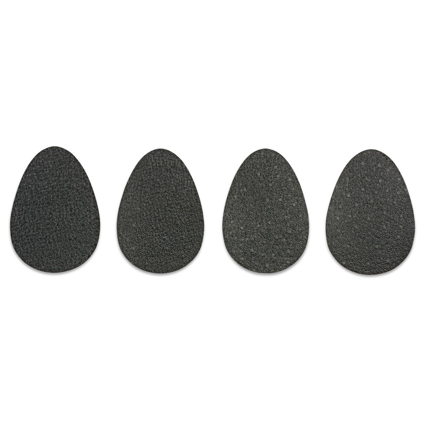 Four black stones are arranged side by side on a white background.