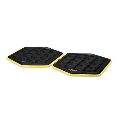 Two black step pads with yellow edges are placed on a plain white background