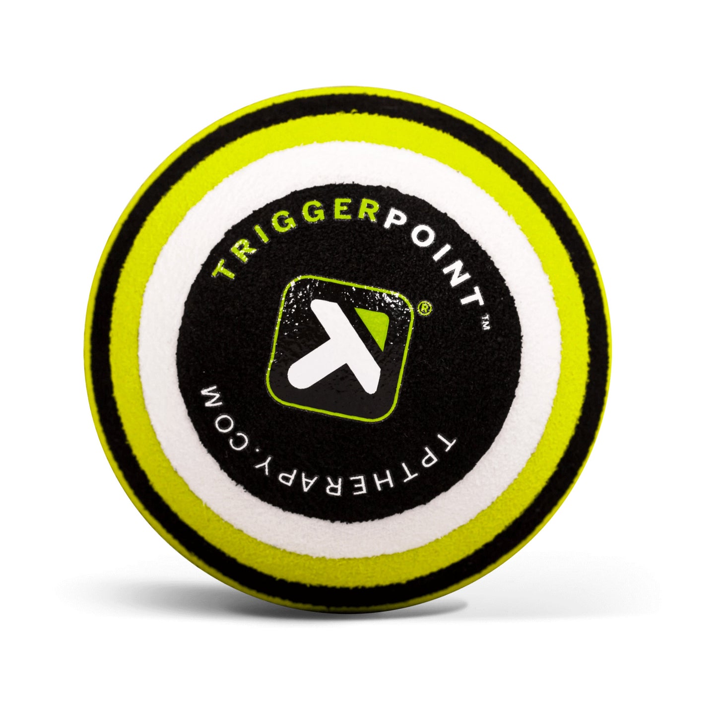 A round foam puck displays the TriggerPoint logo and website, likely used for therapy or sports activities.