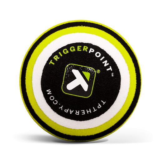 A round foam puck displays the TriggerPoint logo and website, likely used for therapy or sports activities.
