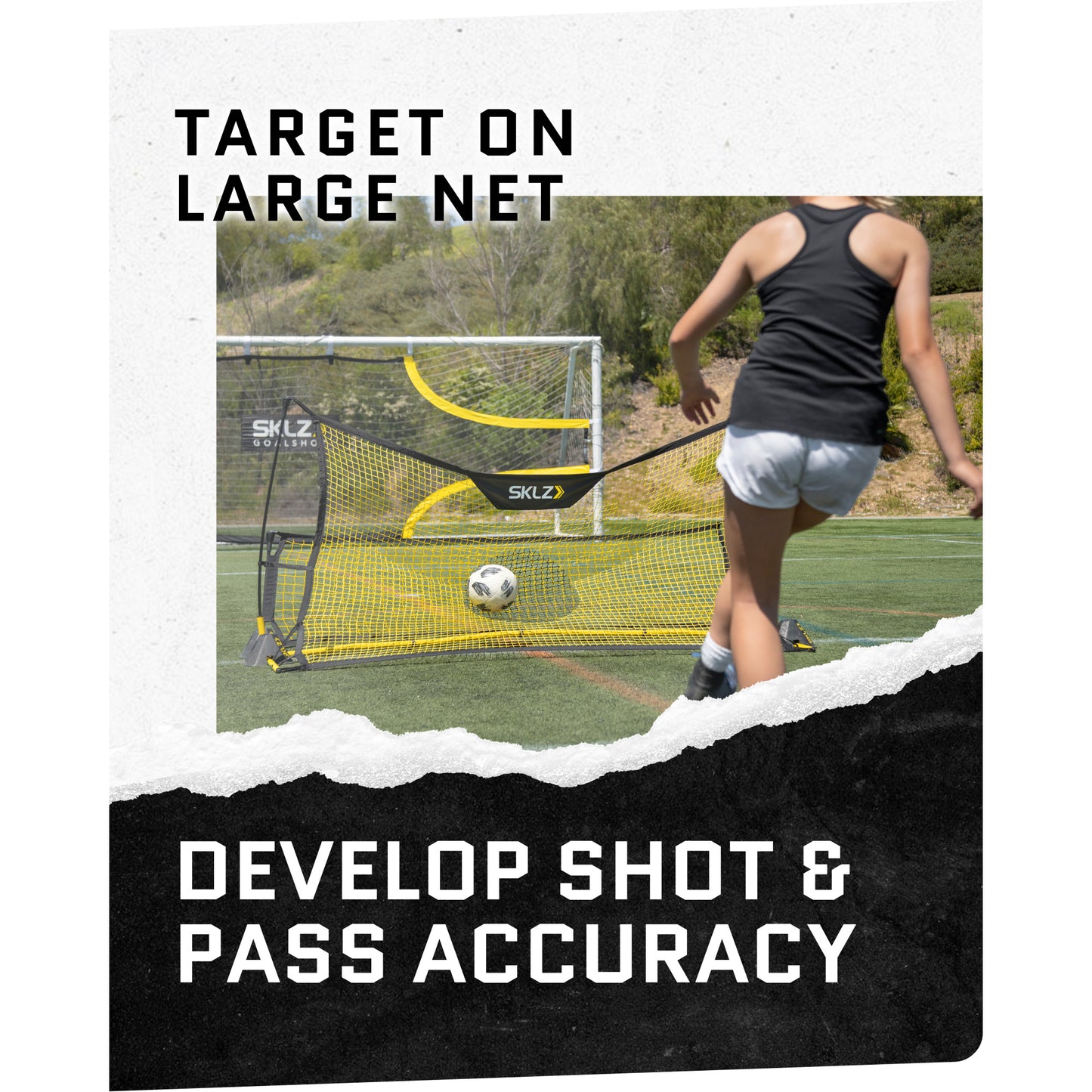 A person kicks a soccer ball into a large net on a field for training or practice