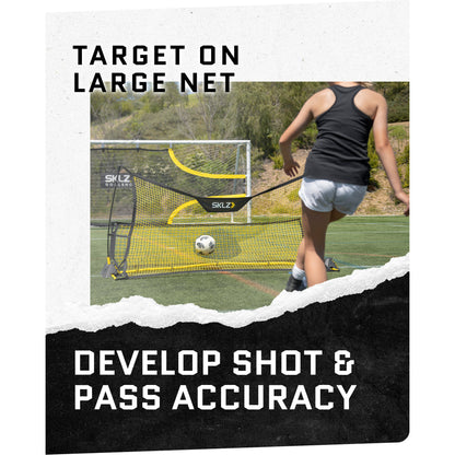 A person kicks a soccer ball into a large net on a field for training or practice