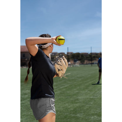 Girl prepares to throw a softball on a field during practice