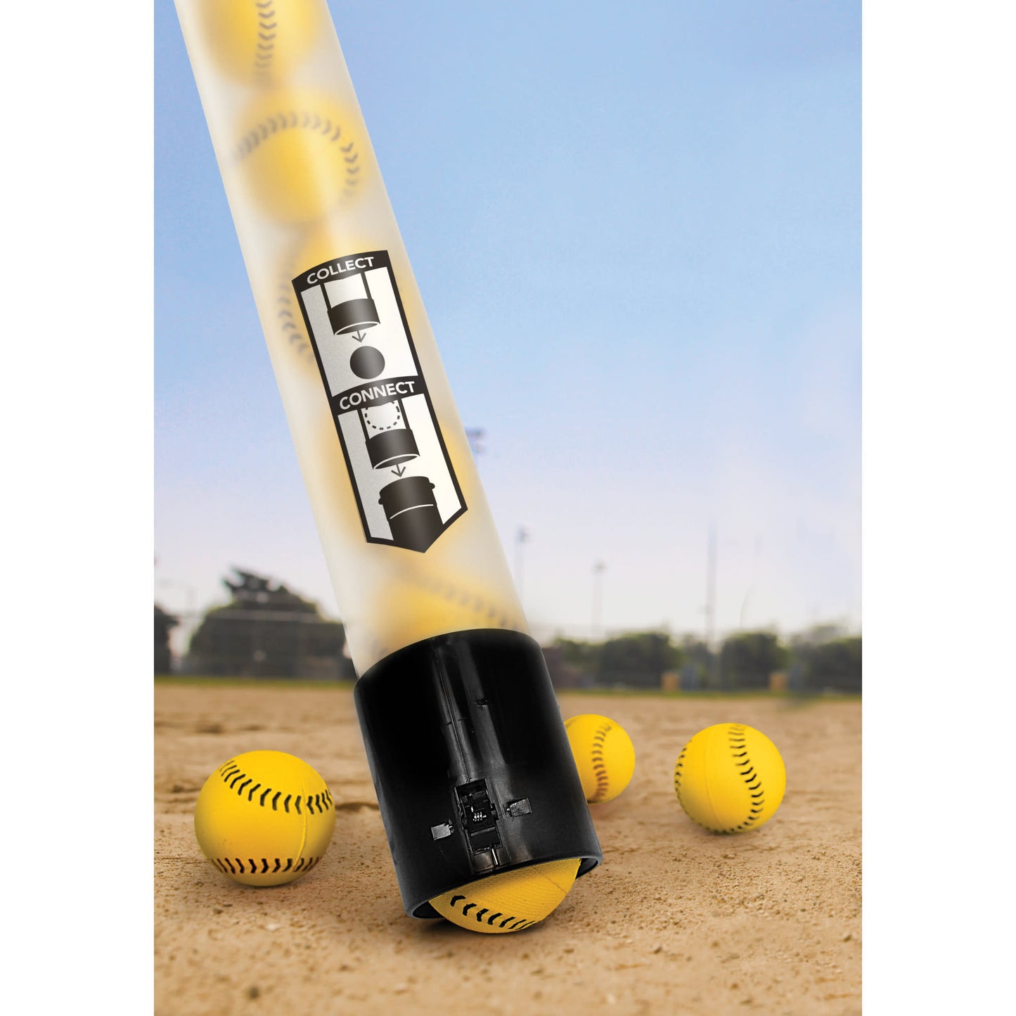 A pitching machine connects to balls on a dirt field for baseball practice