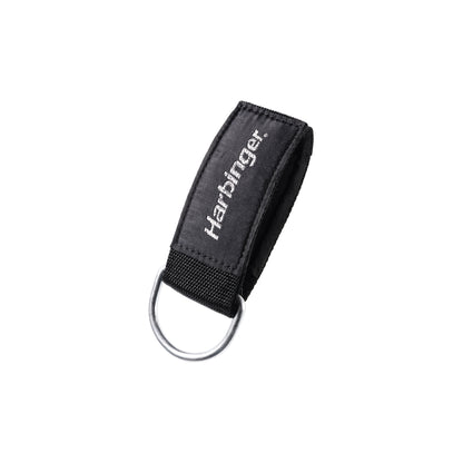 A keychain holder secures keys in a black fabric loop with a metal ring in a plain environment.