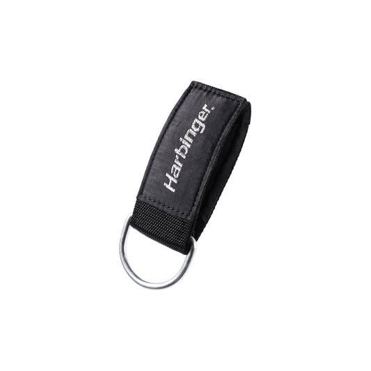 A keychain holder secures keys in a black fabric loop with a metal ring in a plain environment.