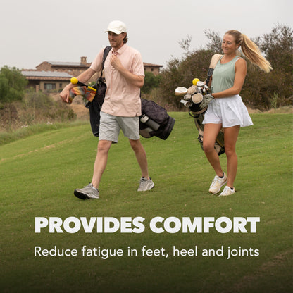 Two people walk on a golf course carrying golf bags, offering comfort and reducing fatigue.