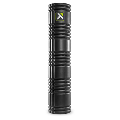 A black foam roller supports stretching exercises in a fitness environment.