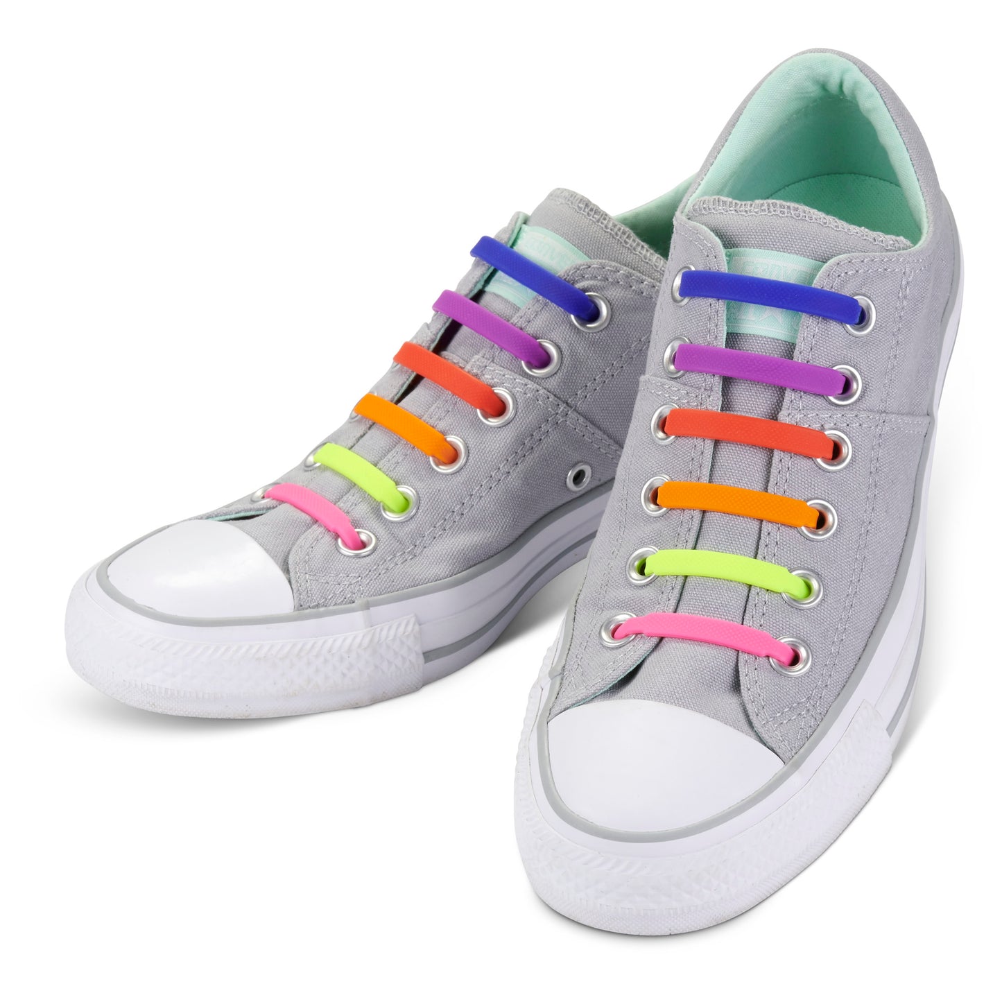 Gray sneakers with rainbow-colored laces in a bright shoe store display.