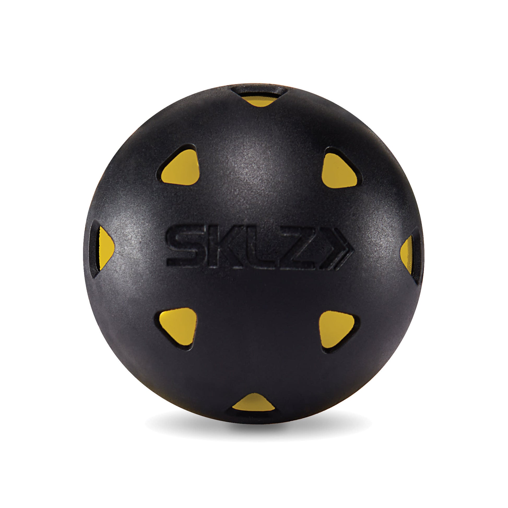A black medicine ball with yellow accents rests on a white background