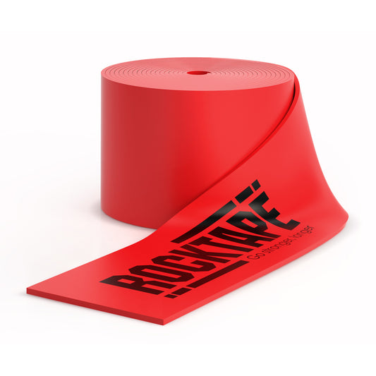 A roll of red warning tape with black text unspools in a white space.
