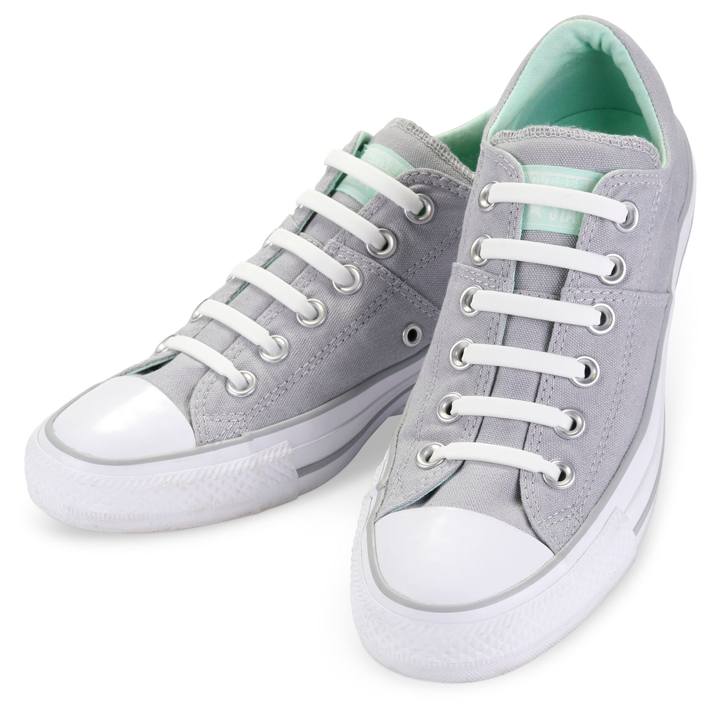 Gray sneakers with white laces and soles resting on a white surface.