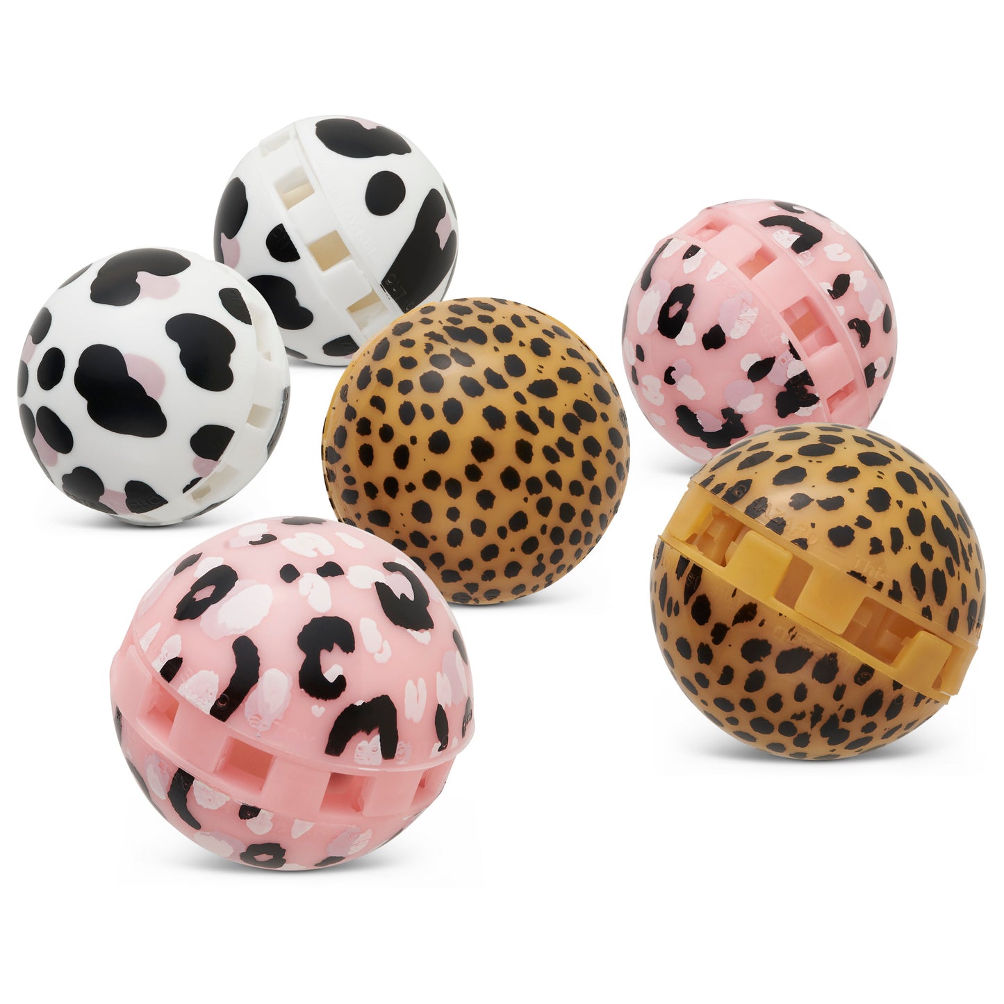 Six spherical objects with animal print patterns are arranged outdoors on a white surface.