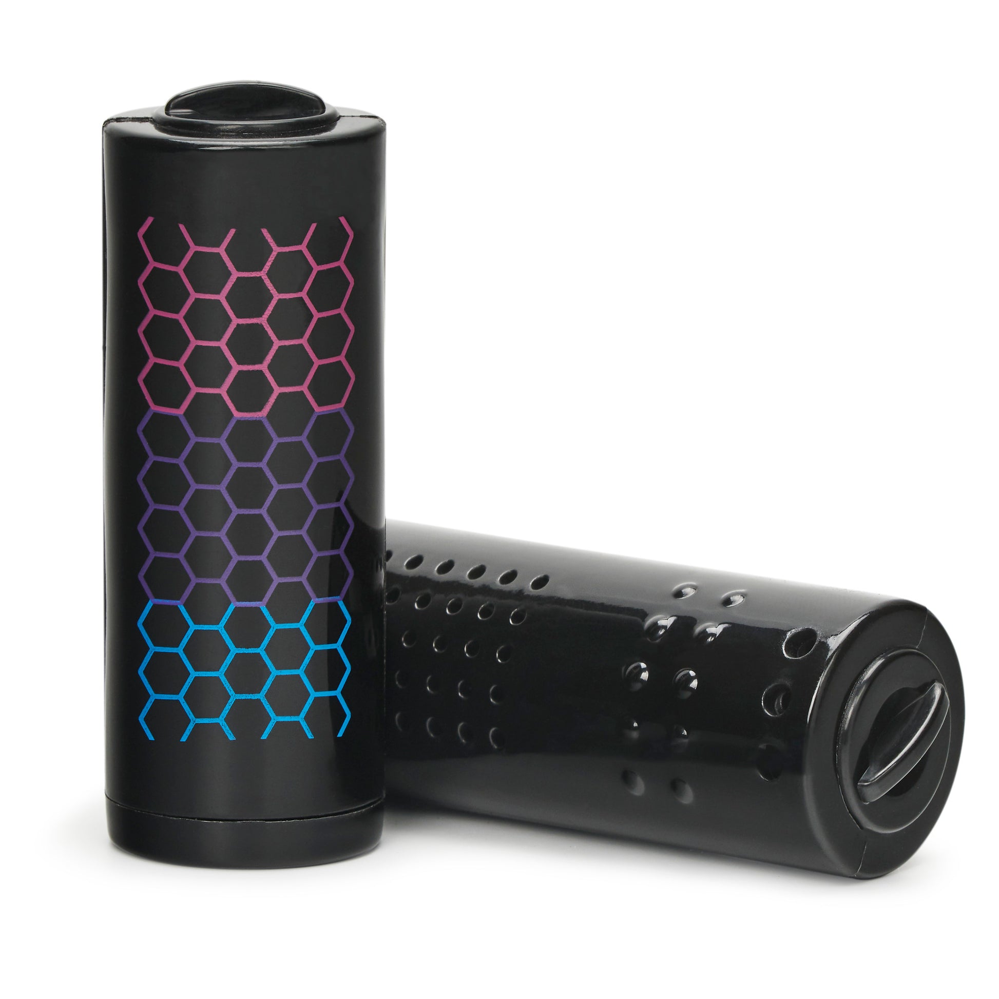 Black cylindrical pods with colorful hexagonal pattern resting on a white surface.
