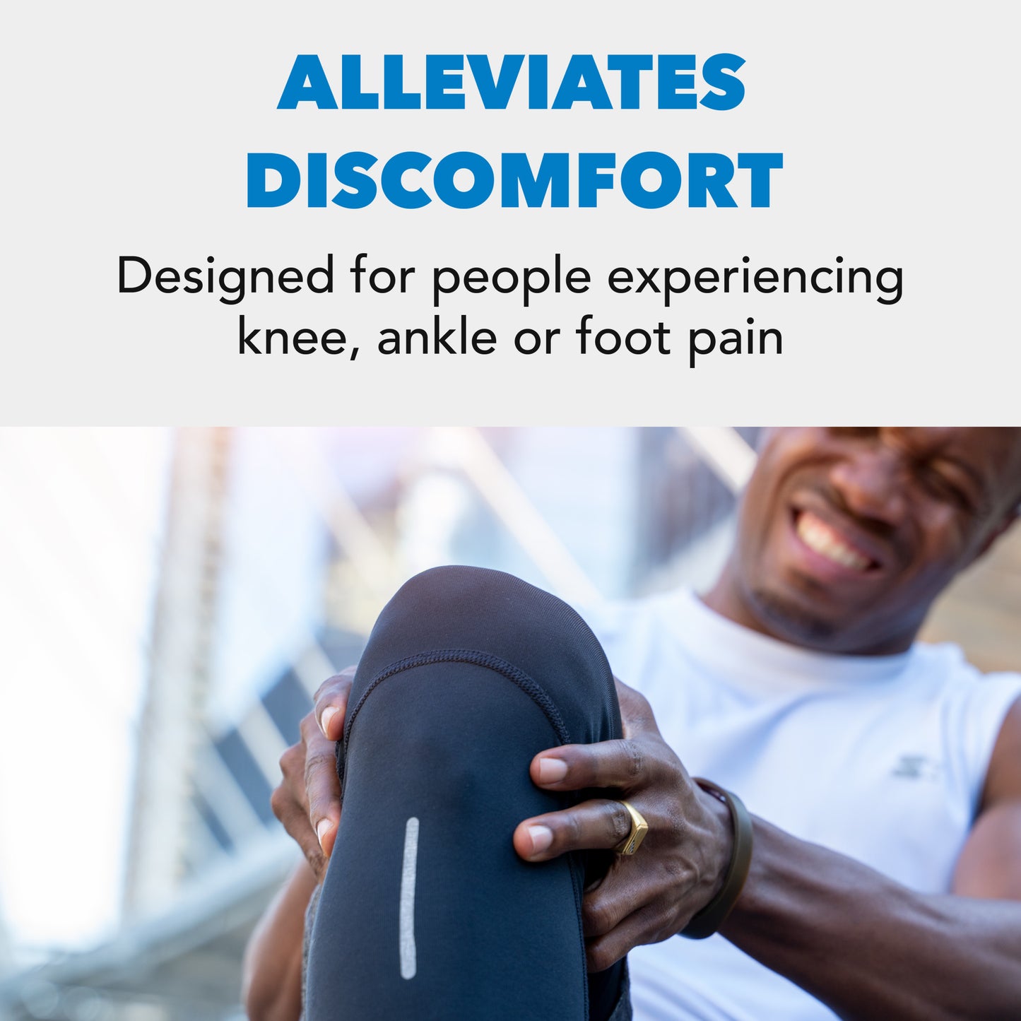 Person grips knee, grimacing outdoors, highlighting pain relief focus.