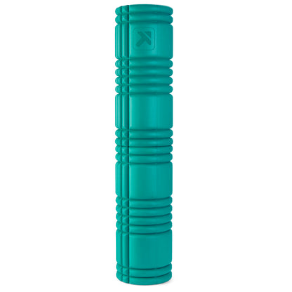 A teal foam roller rests upright on a white background.