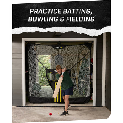 A boy practices batting with a bat in front of a batting cage at home