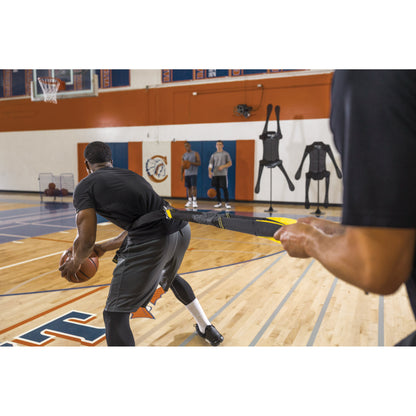 Male athlete using SKLZ Acceleration Trainer with a Coach on a basketball court