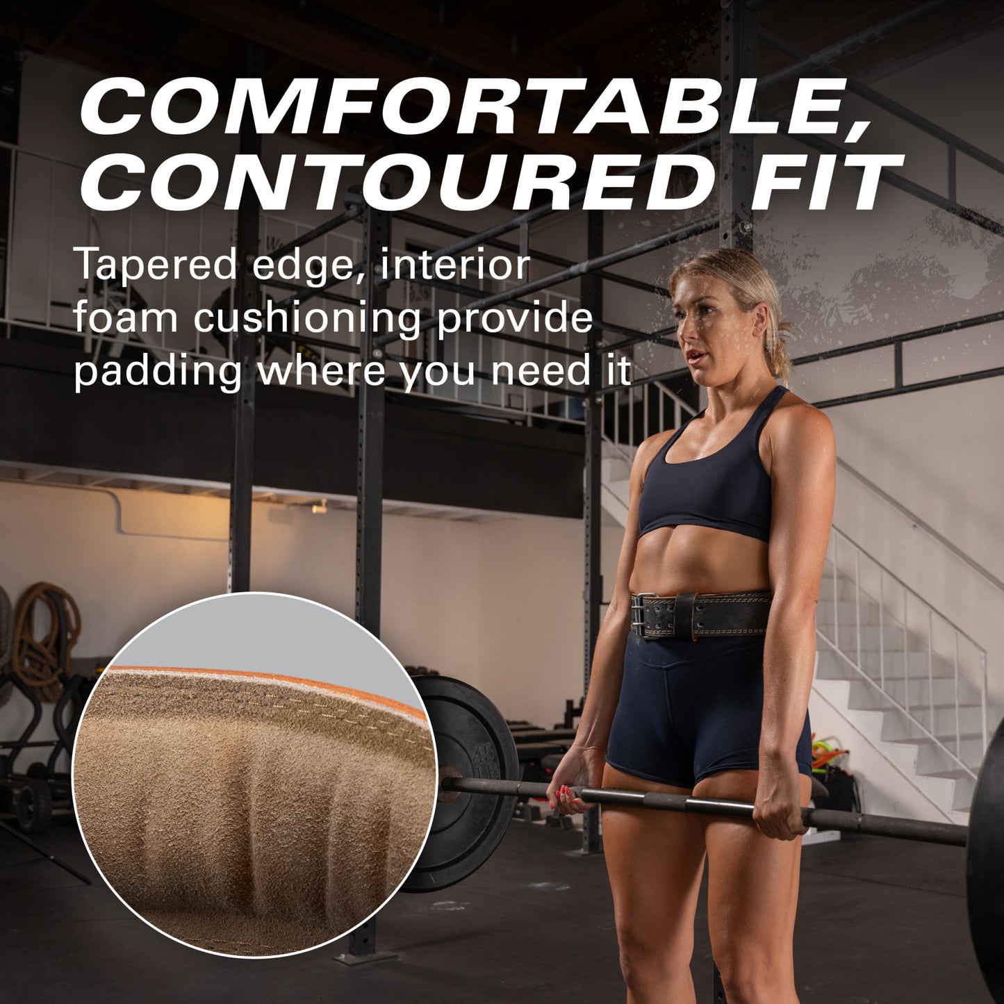 Athlete lifting barbell in gym, wearing a black outfit and supportive belt, surrounded by equipment.