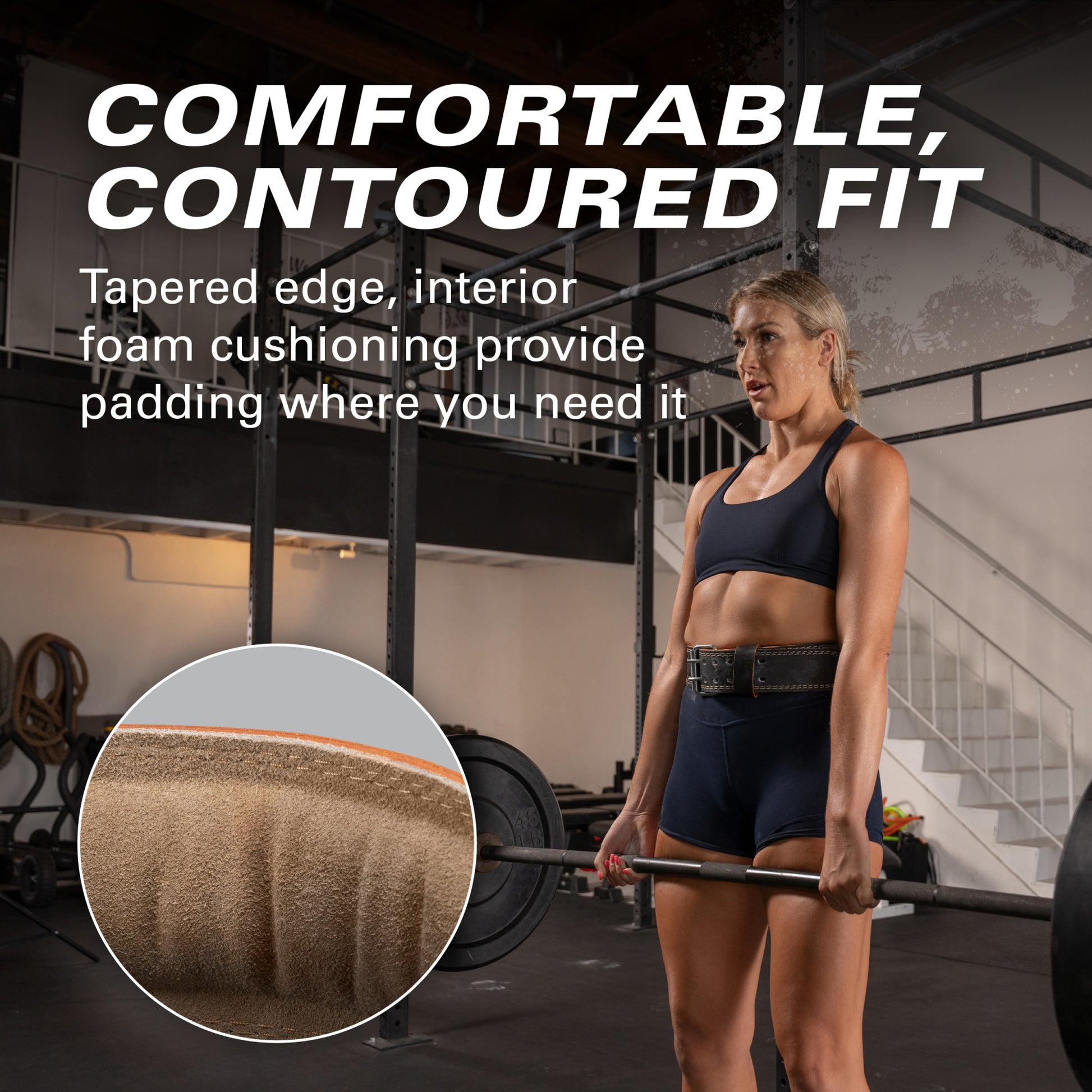 Athlete lifting barbell in gym, wearing a black outfit and supportive belt, surrounded by equipment.