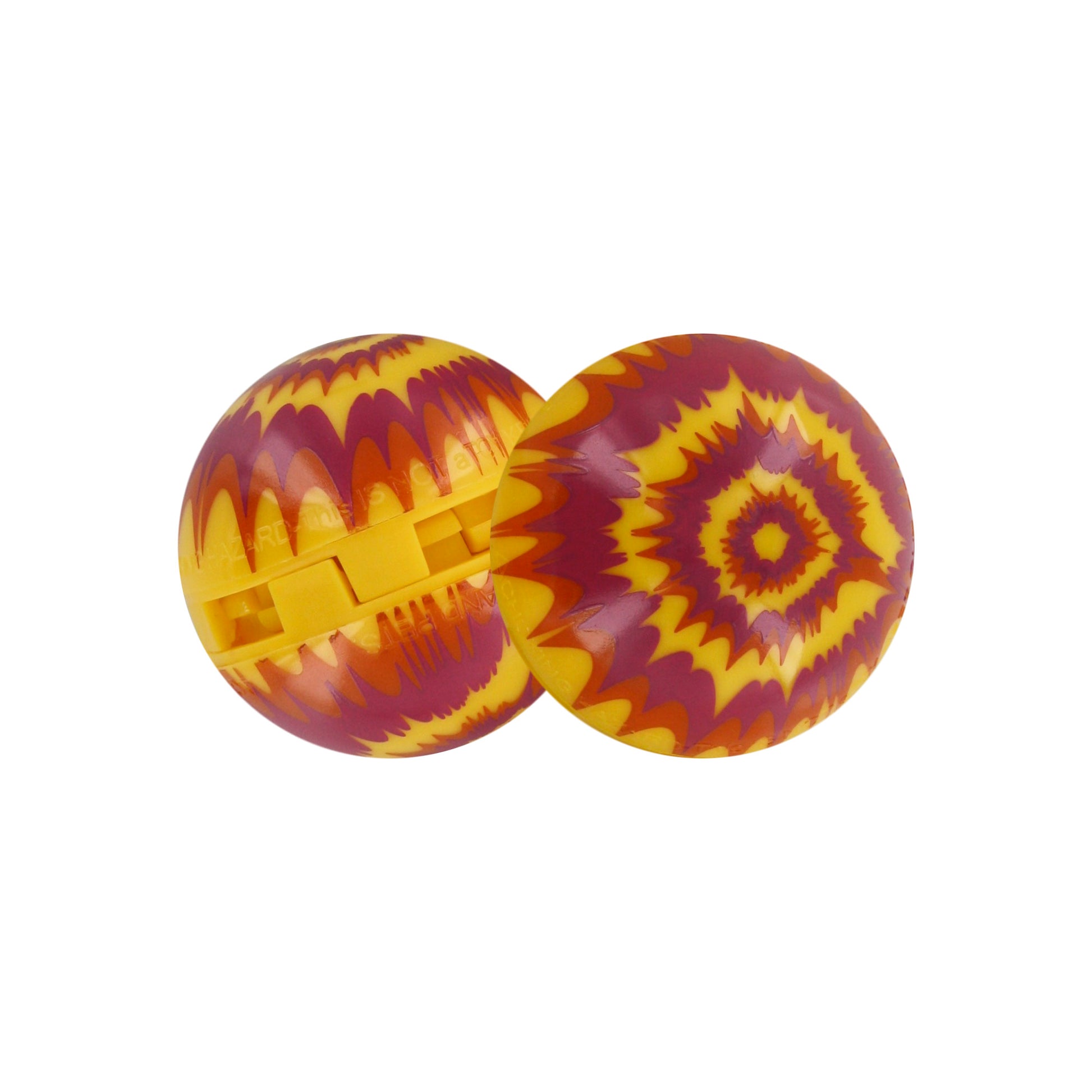 Two plastic marbles with tie-dye patterns roll on a white surface.