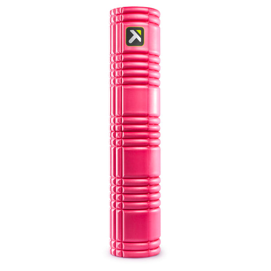A pink foam roller rests vertically on a white background for exercise or therapy use.