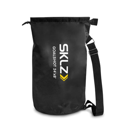 A black waterproof bag with a shoulder strap carrying a goal shot net for sports