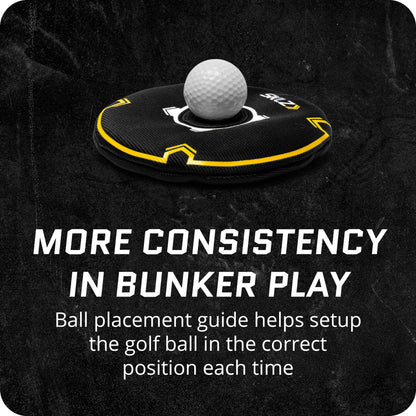 A golf ball on a placement guide for positioning during bunker shots in a practice area