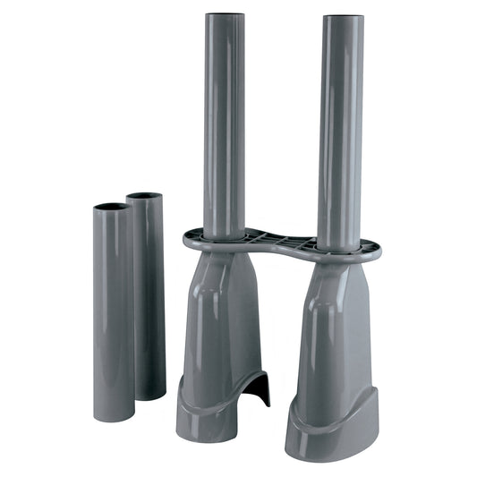 Two gray pipe sections are supported by stands for assembly or installation in a construction environment.