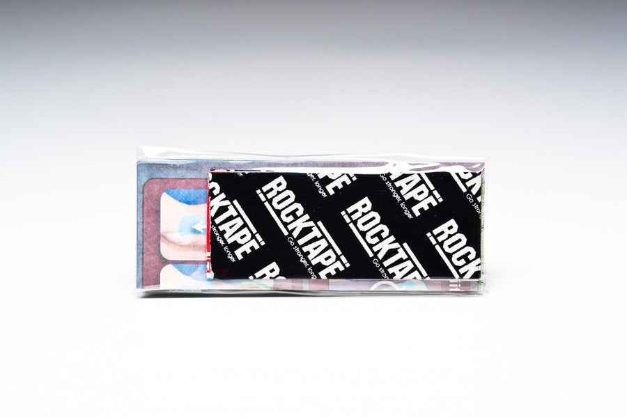 A RockTape bottle is displayed in a clear box packaging with a black and white RockTape label.