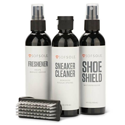 Three spray bottles and a cleaning brush for shoe maintenance on a white background