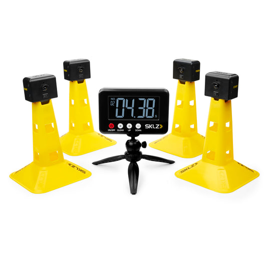 The digital timer displays time while surrounded by four yellow cones with speakers in an indoor setting.