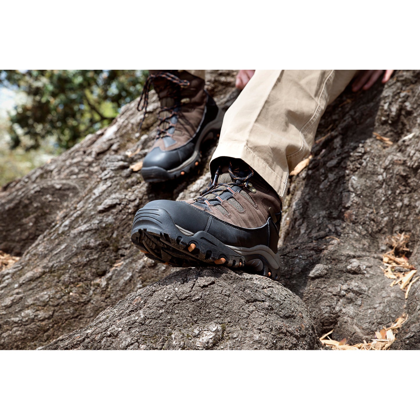 Hiker's boots tread on a rocky trail in an outdoor setting.