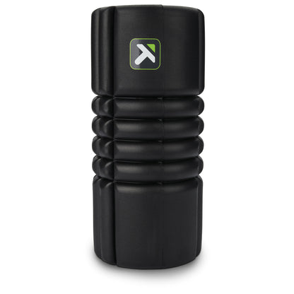 A black foam roller in a vertical position on a plain background for muscle relaxation.