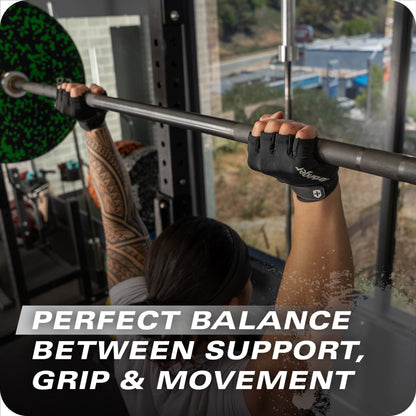 Person lifts a barbell for strength training in a gym with a city view behind.