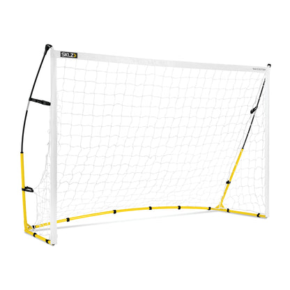 A portable soccer goal stands on a field for practice or game play