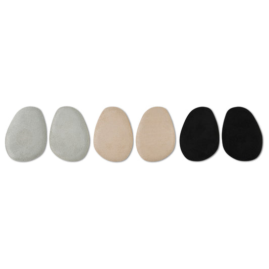 Six stones arranged in a line on a white background showing varying colors and textures.