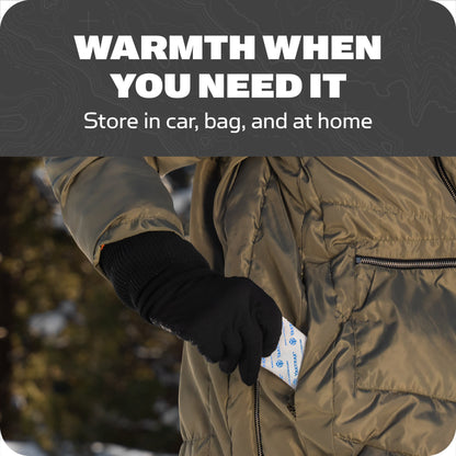 A person inserts a hot pack into a coat pocket to stay warm outdoors