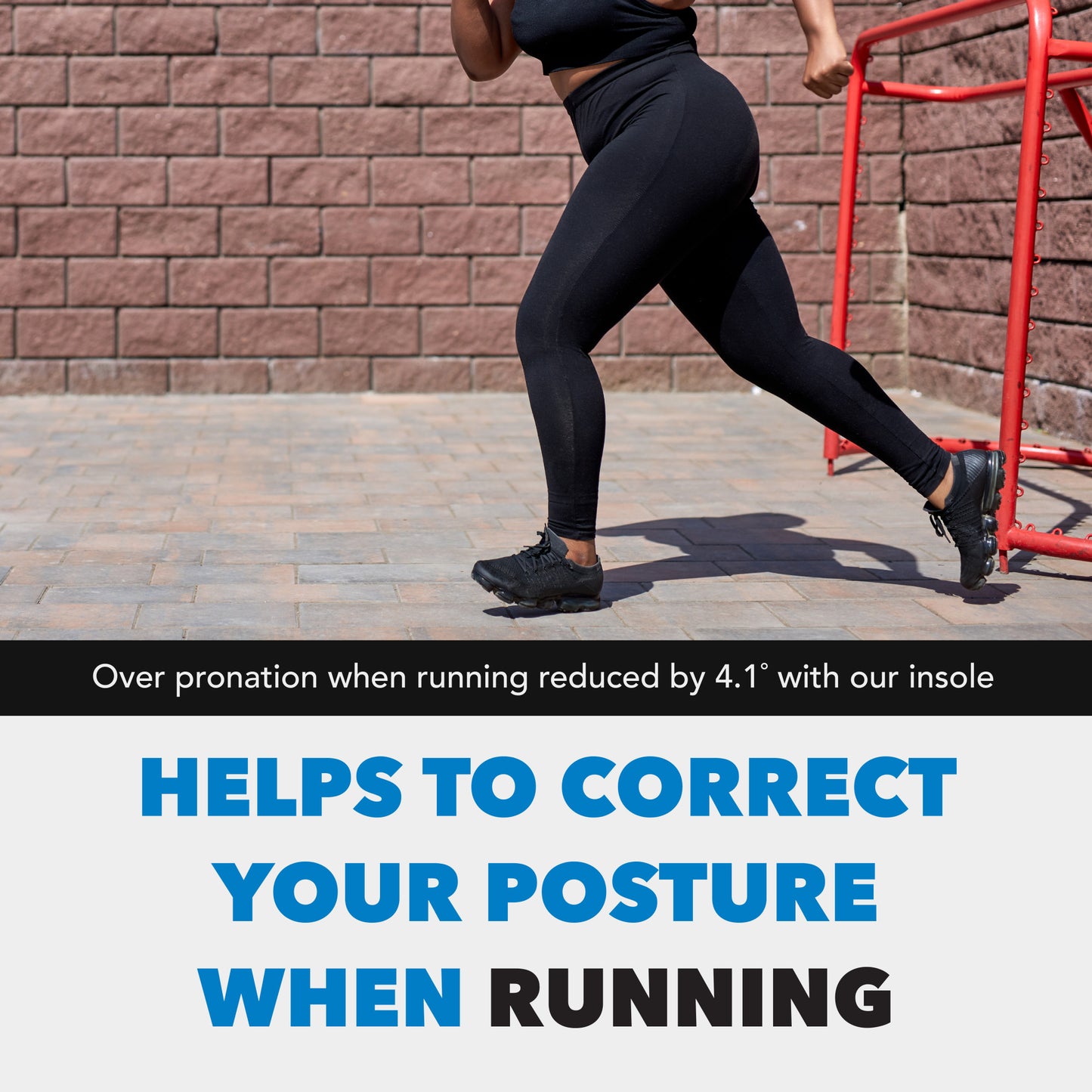 Runner moves forward on a paved path, next to a brick wall and red railing.