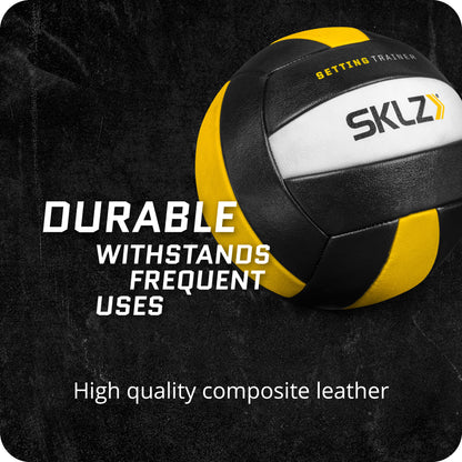 A volleyball with the words setting trainer on it on a black surface highlighting durability and quality