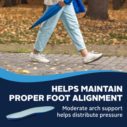 Person walks on cobblestone path carrying an umbrella, outdoor park setting with autumn leaves.