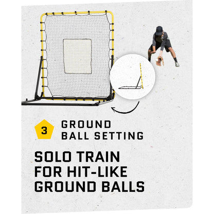A person practices hitting ground balls against a net in an outdoor training area