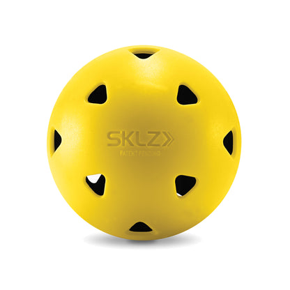 A yellow sports ball with multiple black ventilation holes on a white background