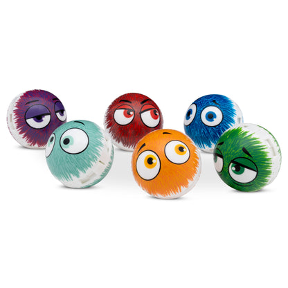 Colorful fuzzy balls with cartoon eyes sit on a white surface against a white background.