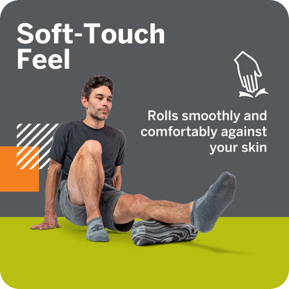 A man uses a soft-touch roller pad on his leg in a home or gym setting.