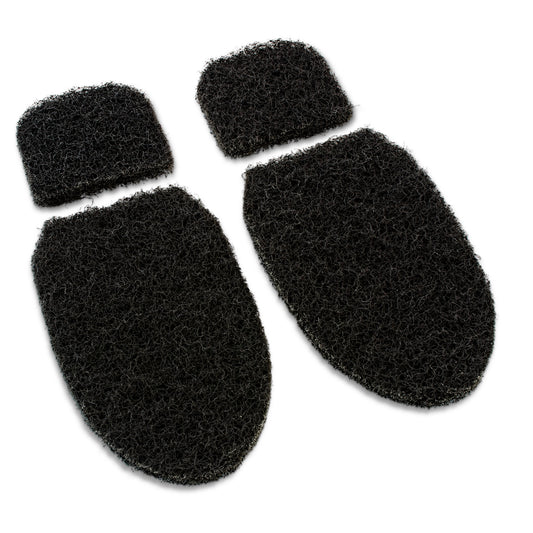 Black foam pads adhere to shoes for cushioning and grip in a sporting environment