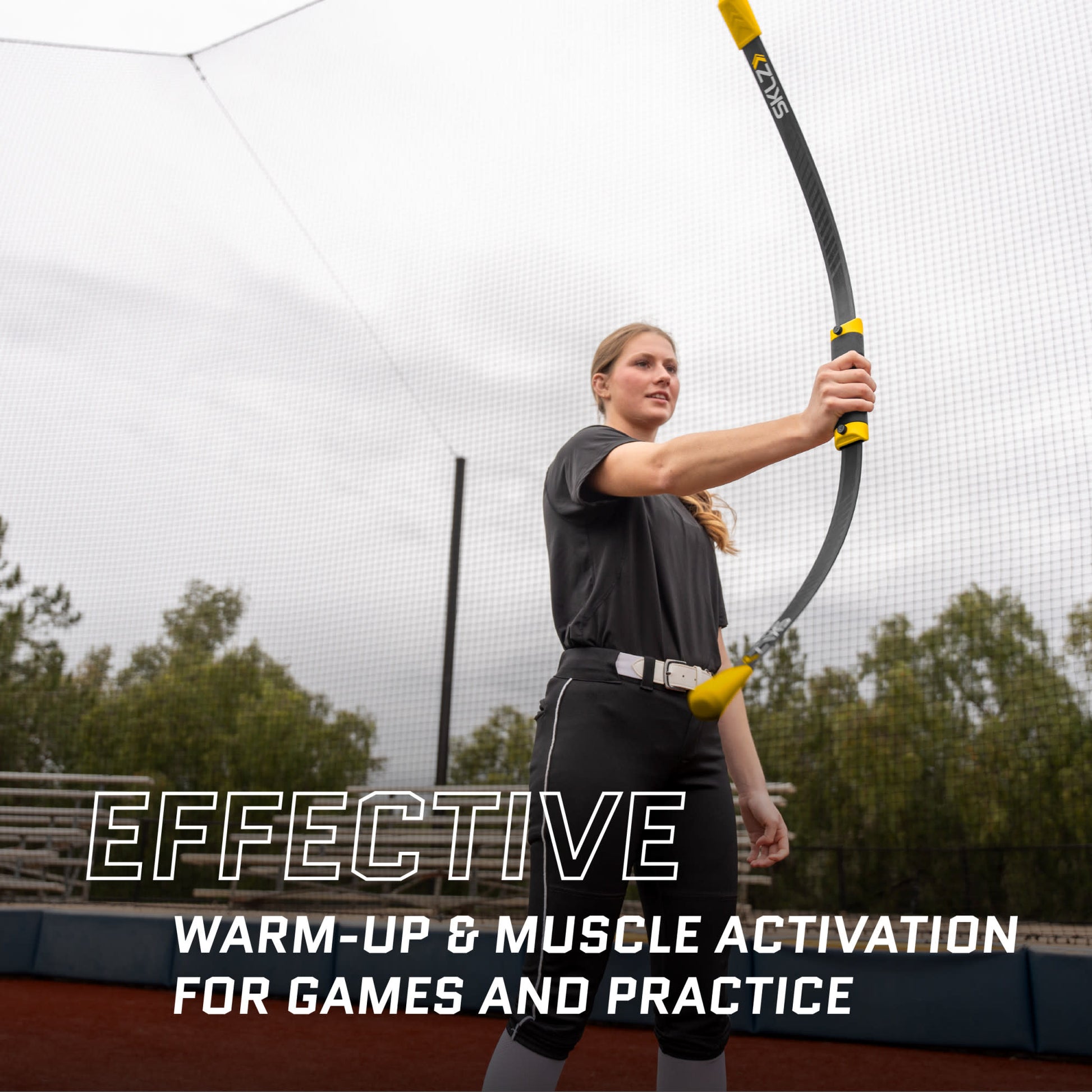 Woman with bow practices on an outdoor tennis court during cloudy weather